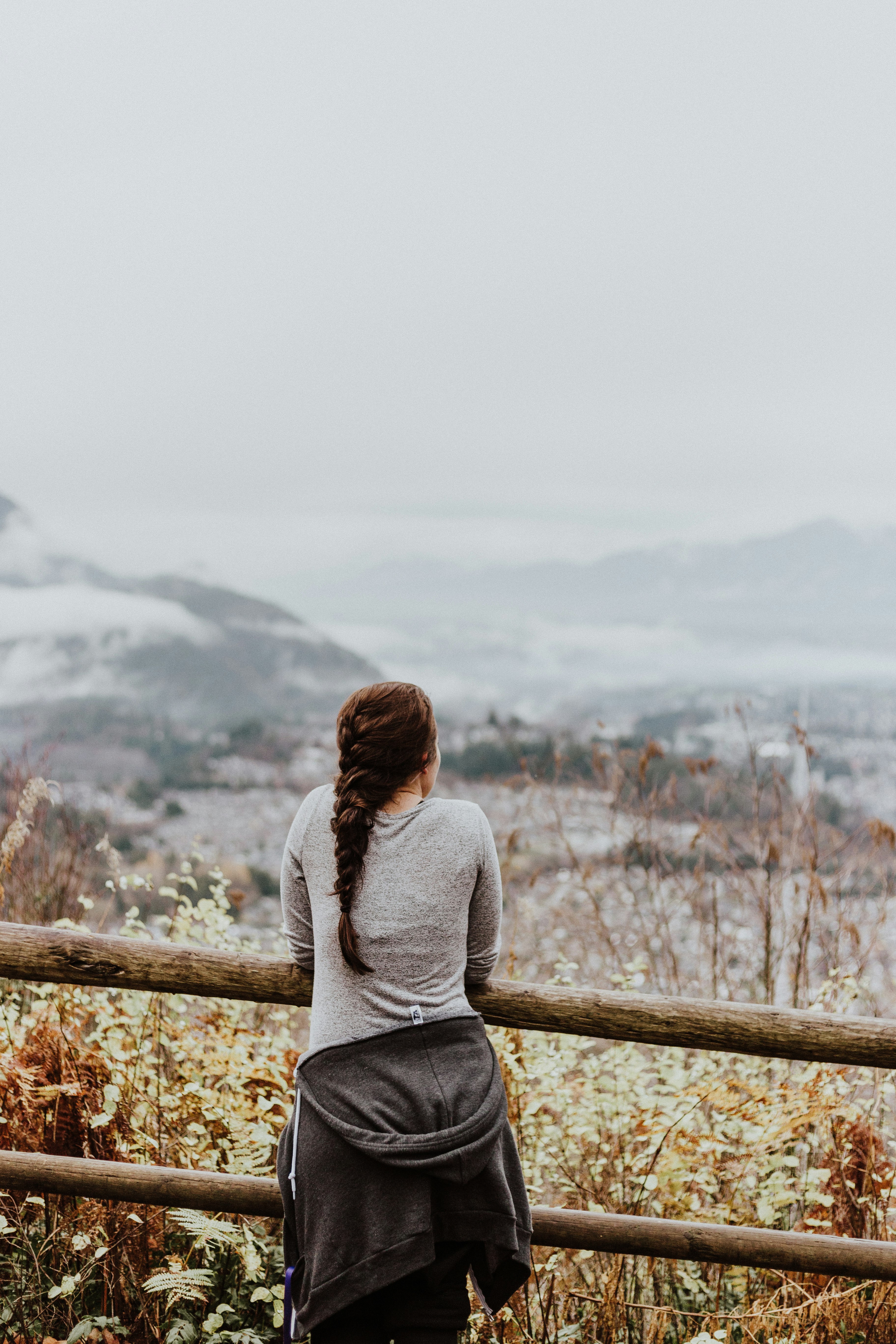 standing woman in grey long-sleeved shirt